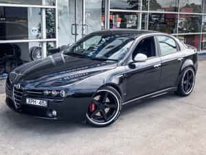 Sleek Alfa Romeo 159 In A Stunning Outdoor Setting Wallpaper