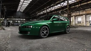 Sleek Alfa Romeo 159 On Open Road Wallpaper