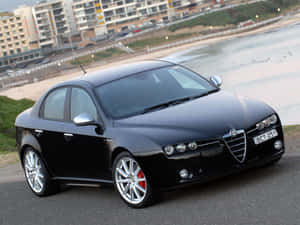 Sleek Alfa Romeo 159 On The Road Wallpaper