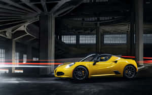 Sleek Alfa Romeo 4c Sports Car On A Scenic Road Wallpaper