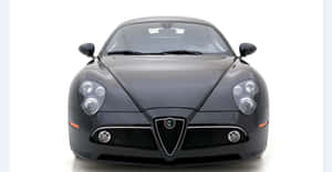 Sleek Alfa Romeo 8c Competizione Cruising The Streets Wallpaper