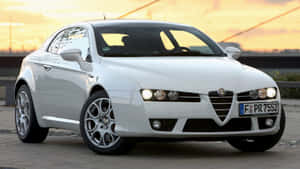 Sleek Alfa Romeo Brera On A Scenic Backdrop Wallpaper