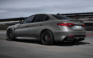 Sleek Alfa Romeo Giulia In Action On The Road Wallpaper