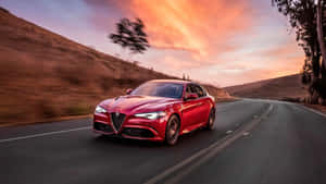 Sleek Alfa Romeo Giulia On An Open Road Wallpaper