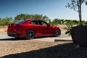 Sleek Alfa Romeo Giulia On The Open Road Wallpaper