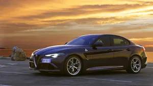 Sleek Alfa Romeo Giulia Showcased Against A Stunning Skyline Wallpaper
