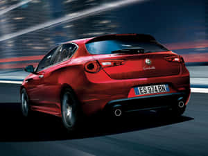 Sleek Alfa Romeo Giulietta Cruising The Streets Wallpaper