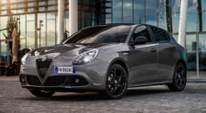 Sleek Alfa Romeo Giulietta In A Serene Outdoor Environment Wallpaper