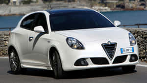 Sleek Alfa Romeo Giulietta In Stunning Scenery Wallpaper