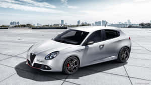 Sleek Alfa Romeo Giulietta On A Scenic Road Wallpaper