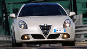 Sleek Alfa Romeo Giulietta On City Streets Wallpaper