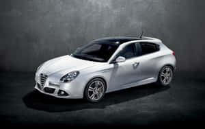 Sleek Alfa Romeo Giulietta On Open Road Wallpaper