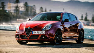 Sleek Alfa Romeo Giulietta On Open Road Wallpaper