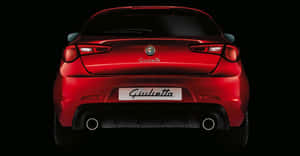 Sleek Alfa Romeo Giulietta On The Open Road Wallpaper