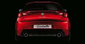 Sleek Alfa Romeo Giulietta On The Open Road Wallpaper