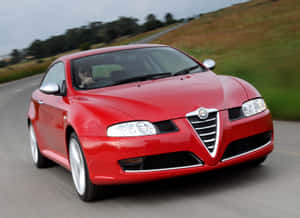 Sleek Alfa Romeo Gt Cruising On Open Road Wallpaper