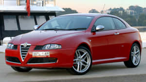 Sleek Alfa Romeo Gt Cruising On The Open Road Wallpaper