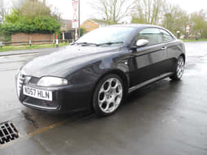 Sleek Alfa Romeo Gt In A Stunning Setting Wallpaper