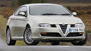 Sleek Alfa Romeo Gt Sports Car On Open Road Wallpaper