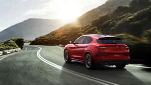 Sleek Alfa Romeo Stelvio In Pristine Condition On Open Road Wallpaper