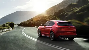 Sleek Alfa Romeo Stelvio In Pristine Condition On Open Road Wallpaper