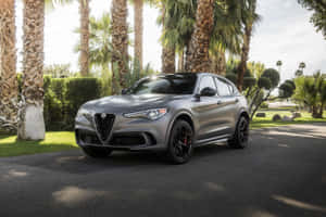 Sleek Alfa Romeo Stelvio On A Scenic Route Wallpaper