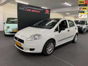 Sleek And Compact Fiat Punto In Urban Setting Wallpaper