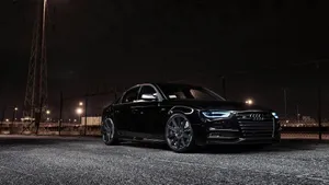 Sleek And Elegant Audi A4 On The Road Wallpaper