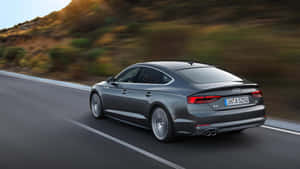 Sleek And Elegant Audi A5 Sportback On The Road Wallpaper