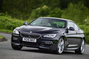 Sleek And Elegant Bmw 6 Series On The Road Wallpaper