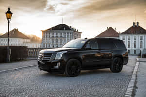 Sleek And Elegant Cadillac Escalade On The Road Wallpaper