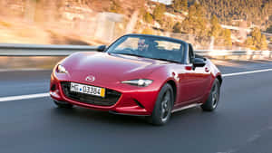 Sleek And Elegant Fiat 124 Spider On The Road Wallpaper