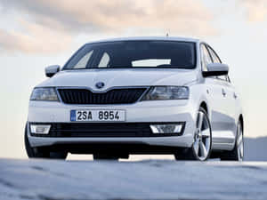 Sleek And Elegant Skoda Rapid In Crisp Night Cityscape Wallpaper