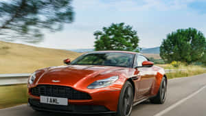 Sleek And Luxurious Aston Martin Db11 On The Road Wallpaper