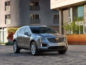 Sleek And Luxurious Cadillac Xt5 In Action On The Highway Wallpaper