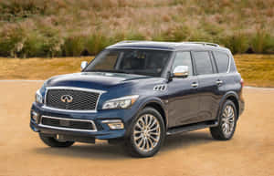 Sleek And Luxurious Infiniti Qx80 On The Road Wallpaper