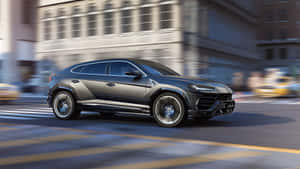 Sleek And Luxurious Lamborghini Urus On The Road Wallpaper