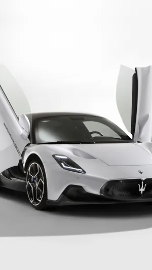 Sleek And Luxurious Maserati Mc20 Against A Vibrant Cityscape. Wallpaper