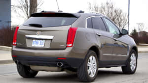 Sleek And Luxurious White Cadillac Srx On Asphalt Road Wallpaper