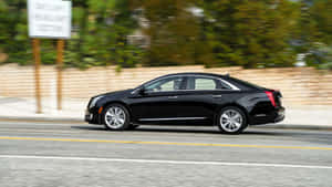 Sleek And Modern Cadillac Xts In An Urban Setting Wallpaper