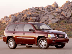 Sleek And Modern Gmc Envoy On The Road Wallpaper