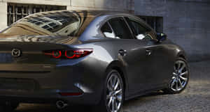 Sleek And Modern Mazda 3 Hatchback On Urban Road Wallpaper