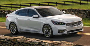 Sleek And Modern White Kia Cadenza In Action Wallpaper