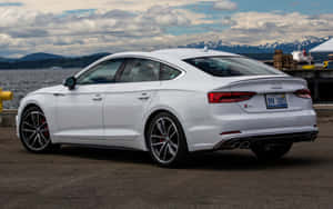 Sleek And Powerful Audi S5 In A Stunning Landscape Wallpaper