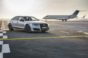 Sleek And Powerful Audi S8 On The Open Road Wallpaper