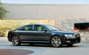 Sleek And Powerful Audi S8 On The Open Road Wallpaper