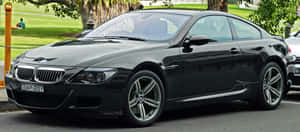 Sleek And Powerful Bmw M6 On The Road Wallpaper