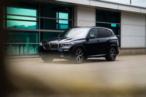 Sleek And Powerful Bmw X5 In Motion Wallpaper