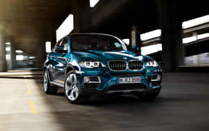 Sleek And Powerful Bmw X6 On The Road Wallpaper