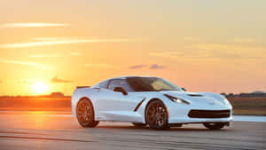 Sleek And Powerful Chevrolet Corvette Z06 On The Open Road Wallpaper